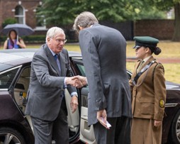 Duke of Gloucester getting out of a car and shaking hands with the Lord Lieutenant